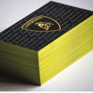 A stack of 32pt uncoated business cards with a Lamborghini logo on them, featuring coloured edges can be replaced with "32pt Uncoated Business Cards + Coloured Edge".