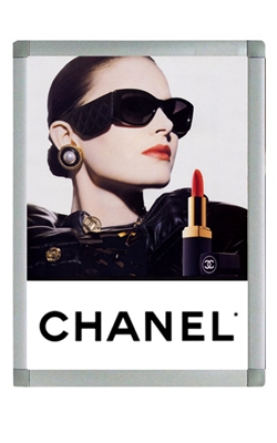 An advertisement for Chanel featuring a woman wearing sunglasses framed in Non-LED Snap Frames (One-Sided).